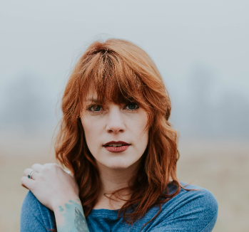Red-haired woman in blue coat